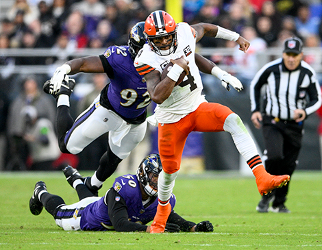 Browns quarterback Deshaun Watson breaks a tackle against the Baltimore Ravens