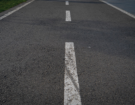 the dotted white line in the middle of a black tar road