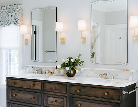 With a mix of dark woods, bright whites and deep blues, this home’s bathroom got a modern uplift while keeping its historical charm in place.