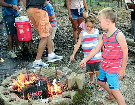  Overnight camp at Hiram House Camp includes campfires and roasting marshmallows.