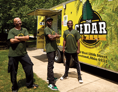 The employees of Cedar Grill stand in front of their food truck