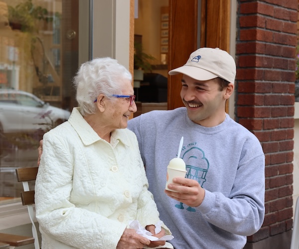 Owner Christopher Giancola sits outside his new storefront with his great-grandmother, Emilia Pinzone, who inspired him to open a granita shop.