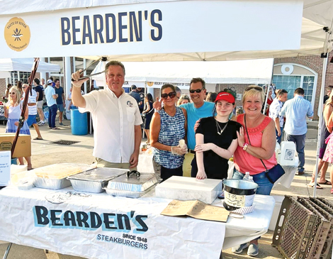 crew at Bearden's smiling behind their booth at Taste of River