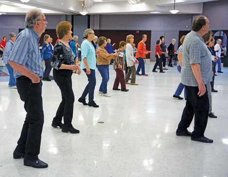 Seniors participating in a line dancing class