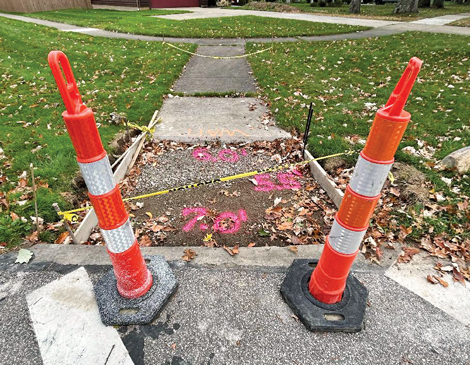 Cones set up by a sidewalk before it is being re-poured
